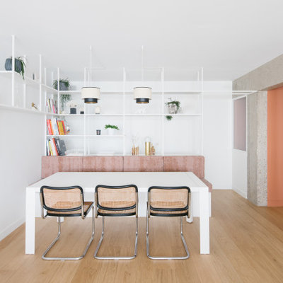 Inspiration for a large contemporary light wood floor and beige floor great room remodel in Paris with white walls and no fireplace