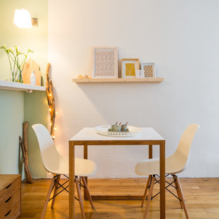 Exemple d'une salle à manger ouverte sur la cuisine scandinave de taille moyenne avec un mur blanc et un sol en bois brun.