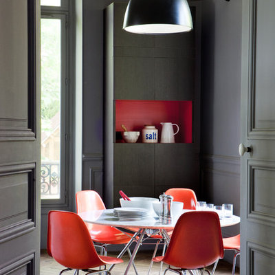 Enclosed dining room - large contemporary medium tone wood floor enclosed dining room idea in Brest with gray walls and no fireplace