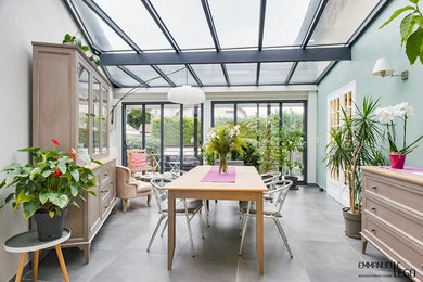 This is an example of a medium sized urban conservatory in Paris with slate flooring, no fireplace and grey floors.