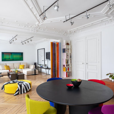 Great room - large contemporary light wood floor and brown floor great room idea in Paris with white walls and no fireplace
