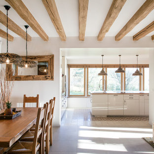 Cette photo montre une salle à manger ouverte sur le salon nature de taille moyenne avec une cheminée double-face et un mur blanc.