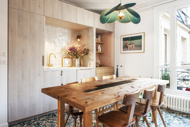 Inspiration for an eclectic multicolored floor dining room remodel in Paris with white walls