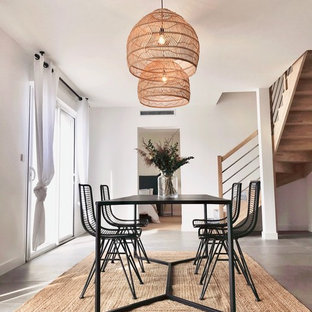 Idée de décoration pour une salle à manger nordique avec béton au sol, un sol gris et un mur blanc.