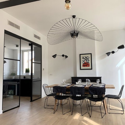 Mid-sized trendy light wood floor and beige floor great room photo in Marseille with white walls, a standard fireplace and a plaster fireplace
