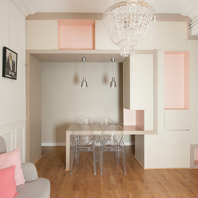 Mid-sized trendy medium tone wood floor great room photo in Paris with white walls and no fireplace