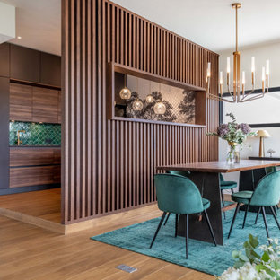 Cette image montre une salle à manger ouverte sur le salon design en bois avec un mur blanc, un sol en bois brun et un sol marron.