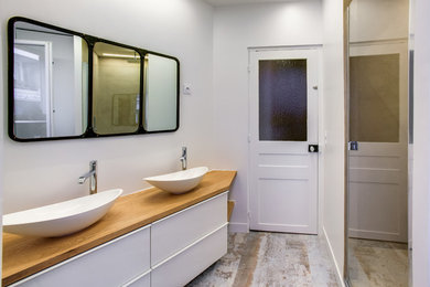 Cette photo montre une salle de bain principale scandinave de taille moyenne avec un mur blanc, un sol en vinyl, une vasque, un sol beige et une cabine de douche à porte battante.
