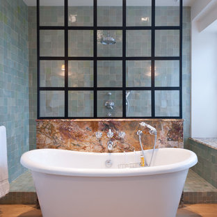 Cette image montre une salle de bain principale bohème de taille moyenne avec une baignoire indépendante, une douche ouverte, un carrelage bleu, un mur bleu, un sol en bois clair et aucune cabine.