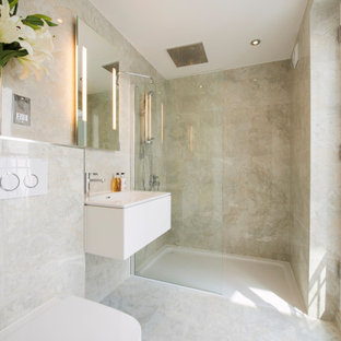 Design ideas for a medium sized contemporary shower room bathroom in London with flat-panel cabinets, white cabinets, an alcove shower, a wall mounted toilet, beige walls, an integrated sink, beige floors and white worktops.