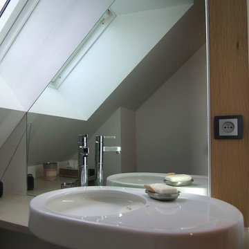 Petite salle de bain avec un miroir à éclairage leds intégré.