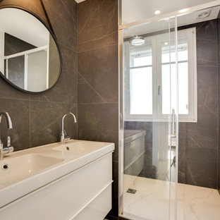 Aménagement d'une salle d'eau scandinave avec un placard à porte plane, des portes de placard blanches, un carrelage gris, un sol blanc, un plan de toilette blanc et un lavabo posé.