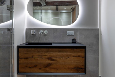 Inspiration for a large contemporary bathroom in Paris with a built-in shower, grey tiles, stone tiles, terracotta flooring, a submerged sink, marble worktops, a hinged door, black worktops, a laundry area, a single sink and a built in vanity unit.
