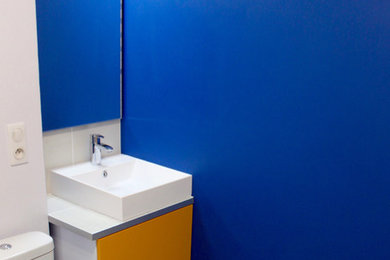 Exemple d'une salle de bain moderne avec un mur bleu, carreaux de ciment au sol, une grande vasque et un sol gris.