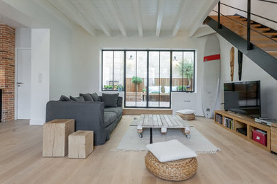Стильный дизайн: большая открытая гостиная комната в современном стиле с белыми стенами, светлым паркетным полом, отдельно стоящим телевизором и ковром на полу без камина - последний тренд