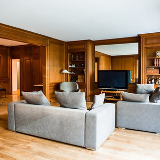 Idée de décoration pour une salle de séjour avec une bibliothèque ou un coin lecture tradition de taille moyenne et ouverte avec un mur marron, un sol en bois brun, aucune cheminée et un téléviseur indépendant.