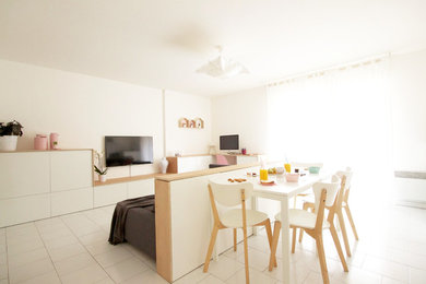 Diseño de sala de estar abierta escandinava de tamaño medio con televisor colgado en la pared y paredes blancas