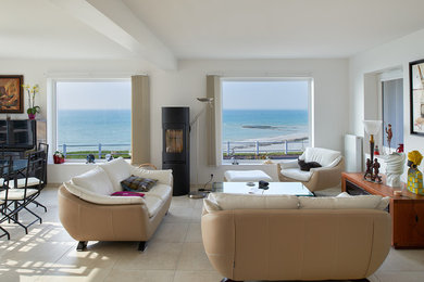 Example of a large minimalist open concept ceramic tile and beige floor family room design in Le Havre with white walls, a wood stove, a metal fireplace and no tv