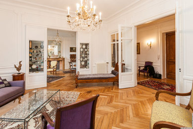 Example of a large ornate open concept light wood floor family room design in Toulouse with white walls, a standard fireplace and a wood fireplace surround
