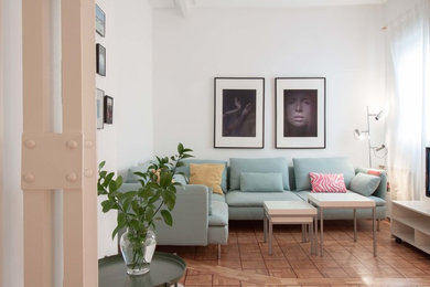 Imagen de salón abierto nórdico pequeño con paredes blancas y suelo de madera en tonos medios