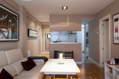 Imagen de salón cerrado contemporáneo de tamaño medio con paredes beige, suelo de madera clara y suelo beige