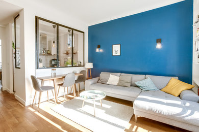 Design ideas for a scandinavian living room in Paris with light hardwood flooring.