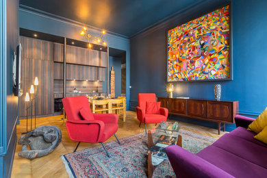Foto di un soggiorno eclettico aperto con pareti blu, pavimento in legno massello medio e pavimento marrone