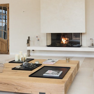 This is an example of a large contemporary formal enclosed living room in Marseille with white walls, a standard fireplace, a plastered fireplace surround and no tv.
