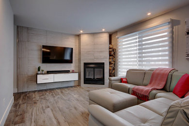 Trendy ceramic tile and gray floor living room photo in Other with gray walls and a tile fireplace