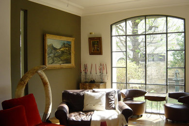 Exemple d'un grand salon tendance ouvert avec un mur marron, parquet foncé, une cheminée standard, aucun téléviseur, un manteau de cheminée en pierre et un sol beige.