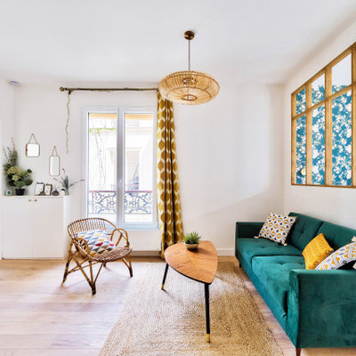 Example of a mid-sized danish open concept light wood floor living room design in Paris with white walls, no fireplace and a tv stand