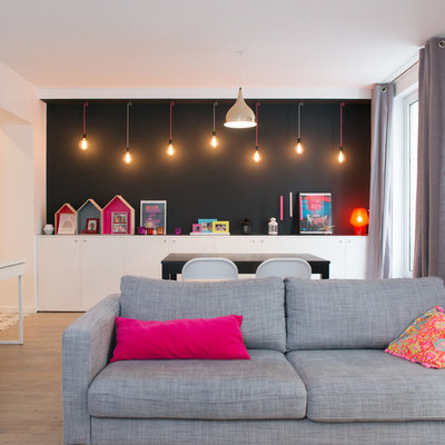 Living room - mid-sized scandinavian open concept light wood floor living room idea in Paris with black walls and no fireplace