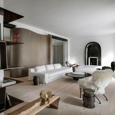 Large danish formal and open concept light wood floor living room photo in Paris with white walls, a standard fireplace, a metal fireplace and no tv