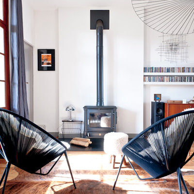 Inspiration for a large scandinavian open concept medium tone wood floor living room remodel in Bordeaux with white walls, a wood stove and no tv