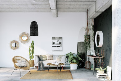 World-inspired living room in Lyon with white walls, concrete flooring and grey floors.