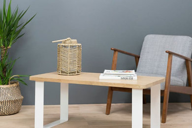 Cette image montre un salon minimaliste avec un mur gris, parquet clair, aucun téléviseur et un sol beige.