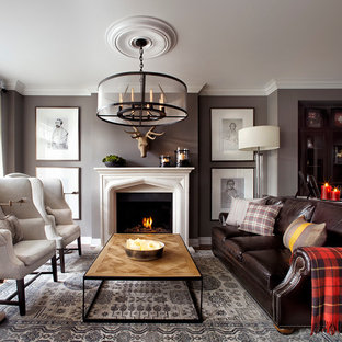 Cette image montre un salon beige et marron bohème de taille moyenne et ouvert avec un mur gris, une cheminée standard, un manteau de cheminée en pierre, aucun téléviseur et une salle de réception.