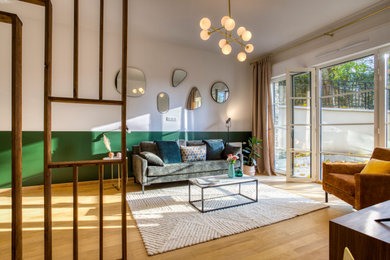 Idées déco pour un salon classique de taille moyenne et ouvert avec un mur vert, parquet clair, un téléviseur indépendant et un sol marron.