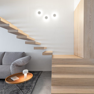 Idee per una grande scala a rampa dritta design con pedata in legno e nessuna alzata