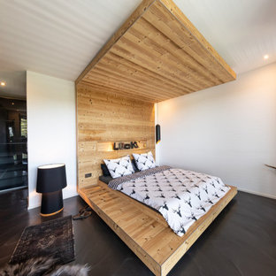 Esempio di un'ampia camera da letto stile loft shabby-chic style con pareti bianche, pavimento in cemento e pavimento nero