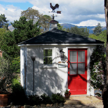 A small Americana style White She Shed by Jeff Doubet with Repurposed Red Door