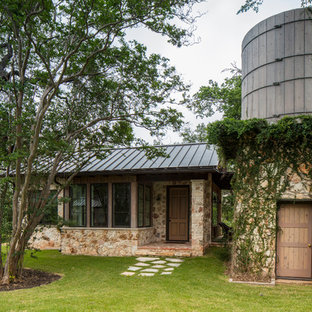 Example of a country detached guesthouse design in Austin