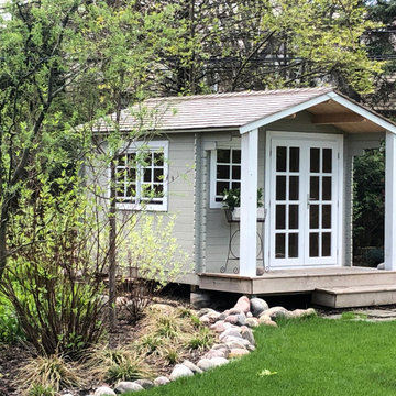 Cottage Storage Shed With Custom Pillars and Patio