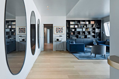 Cette image montre un salon design de taille moyenne avec une bibliothèque ou un coin lecture, un mur marron et un sol en bois brun.