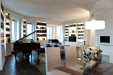 This is an example of a modern games room with white walls, dark hardwood flooring, a ribbon fireplace, a plastered fireplace surround, a concealed tv and brown floors.