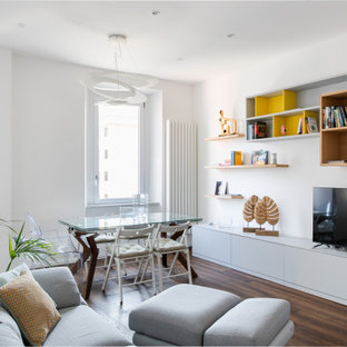 Immagine di un soggiorno design di medie dimensioni e aperto con pareti bianche, pavimento in legno massello medio, TV autoportante e pavimento marrone