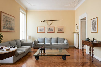 Idee per un grande soggiorno moderno chiuso con sala formale, pareti gialle e pavimento in legno massello medio
