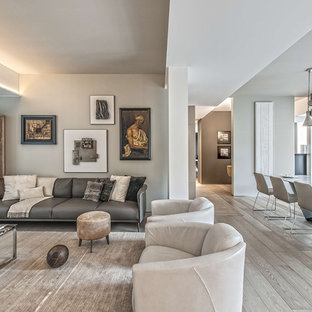 Design ideas for a contemporary formal open plan living room in Milan with white walls and light hardwood flooring.