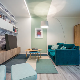 Immagine di un soggiorno minimal di medie dimensioni e aperto con libreria, pareti verdi, pavimento in linoleum, parete attrezzata e pavimento grigio