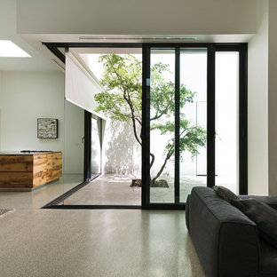 Ispirazione per un grande soggiorno moderno stile loft con pareti bianche, pavimento in cemento, camino lineare Ribbon e pavimento grigio